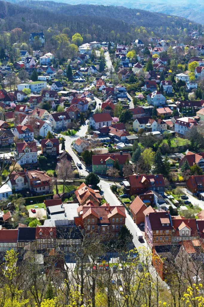 Blick vom Hof des Schlosses Wernigerode auf die Stadt. Eine Straße führt durch die vielen Häuser von unten nach oben.